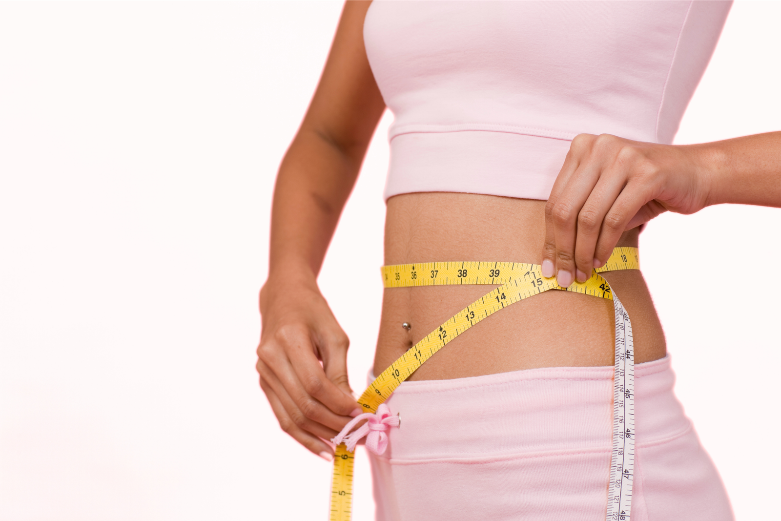 Woman measuring her waist during a medical weight loss program in Nottingham, MD